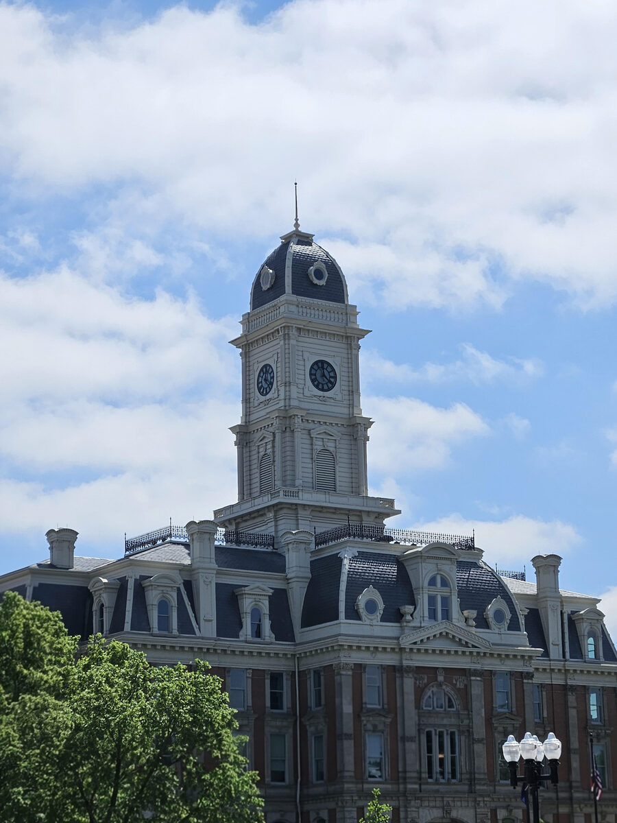 The Hamilton County Courthouse clock tower against a blue sky.
