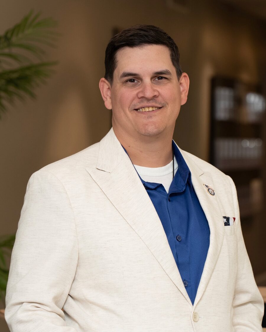 Tim Cortrecht in a cream jacket over a blue shirt.