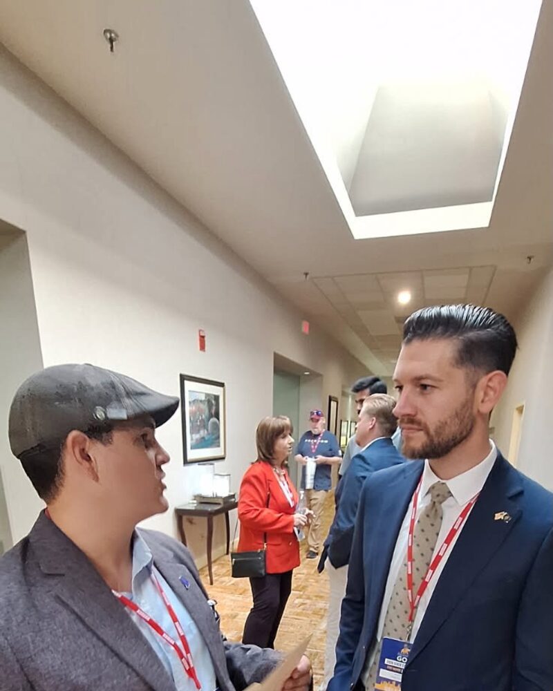 Tim Cortrecht shaking hands with Max Engling in a hallway at an event.